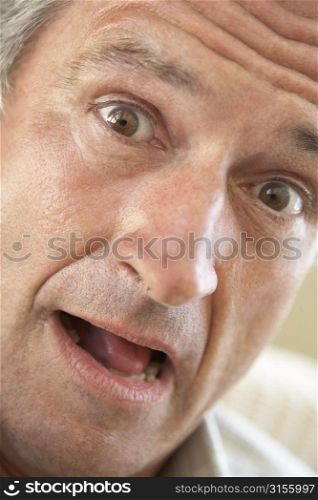 Portrait Of Senior Man Looking At Camera In Surprise