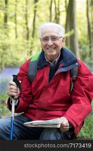 Portrait Of Senior Man On Walk Through Bluebell Wood