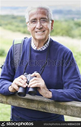 Portrait Of Senior Man On Walk With Binoculars