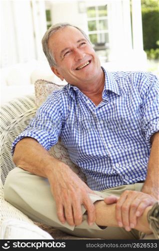 Portrait Of Senior Man Relaxing In Chair