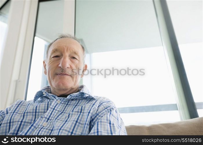Portrait of senior man relaxing in living room