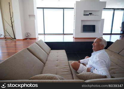 Portrait of senior man relaxing in sofa at home