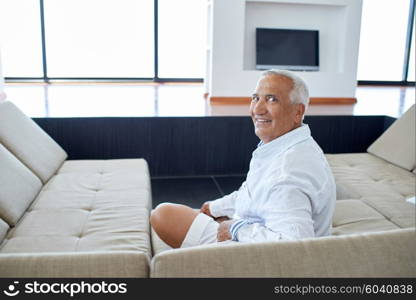 Portrait of senior man relaxing in sofa at home