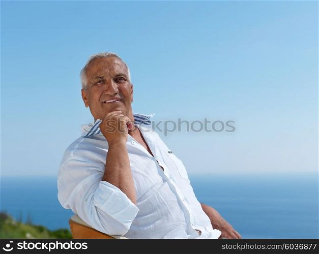 Portrait of senior man sitting outside