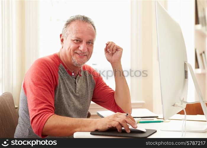Portrait Of Senior Man Using Computer At Home