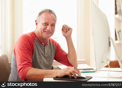 Portrait Of Senior Man Using Computer At Home