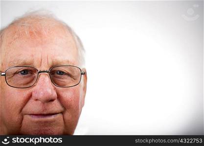 Portrait of senior man wearing glasses, studio shot