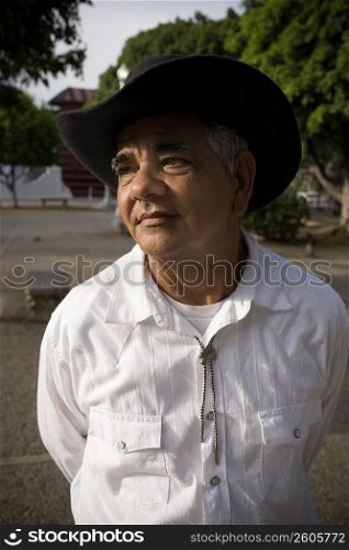 Portrait of senior man wearing hat, outdoor