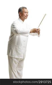Portrait of senior man wearing Tai Chi clothes