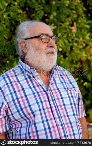 Portrait of senior man with white beard in the garden