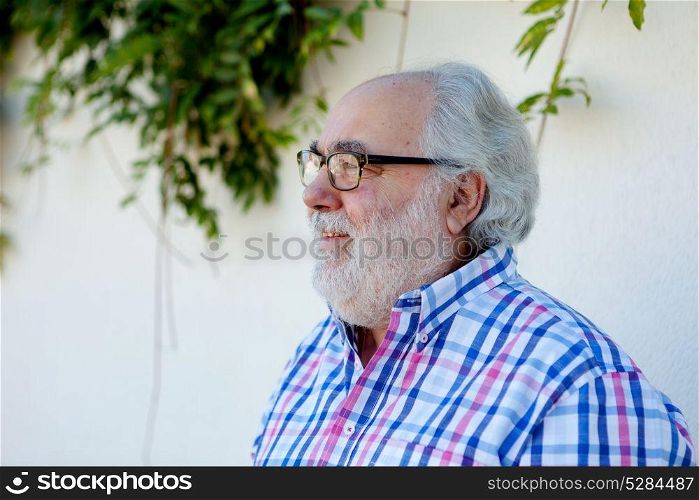 Portrait of senior man with white beard in the street