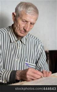 portrait of senior man writing in a notebook