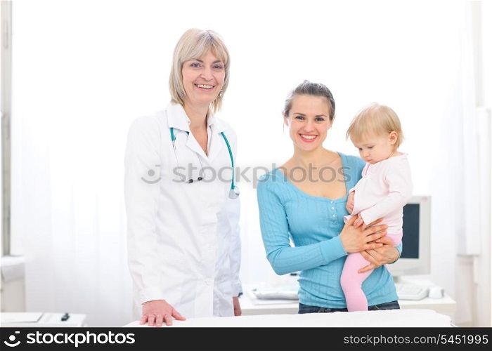 Portrait of senior pediatric doctor and mother with baby