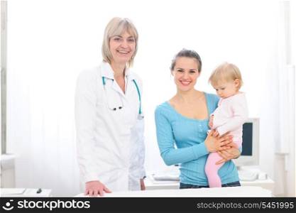Portrait of senior pediatric doctor and mother with baby