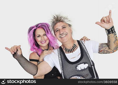 Portrait of senior punk couple over gray background