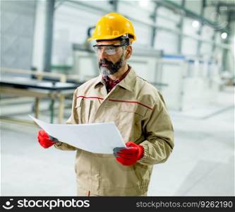 Portrait of senior supervisor looking at projest in the factory