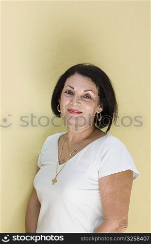 Portrait of senior woman against yellow background