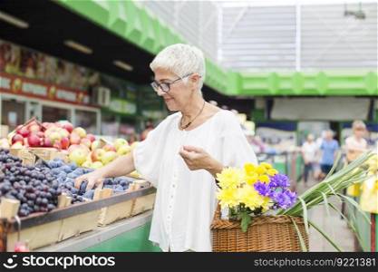 Portrait of senior woman buying fruit on market
