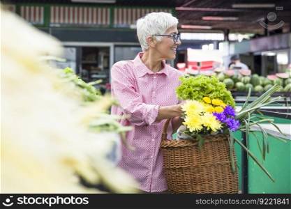 Portrait of senior woman buying on market