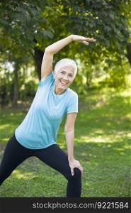 Portrait of senior woman doing streching exercise in the park