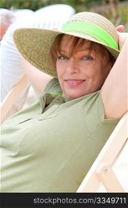 Portrait of senior woman relaxing in deck chair