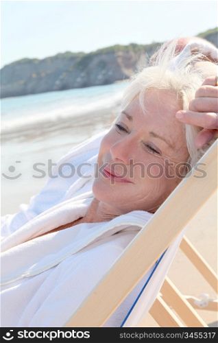 Portrait of senior woman relaxing in longchair