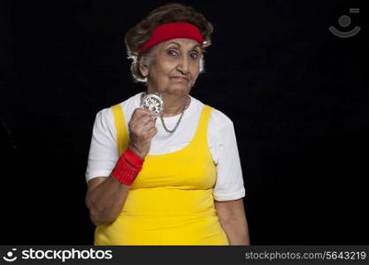 Portrait of senior woman showing necklace