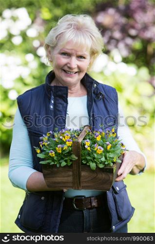 Portrait Of Senior Woman Working In Garden