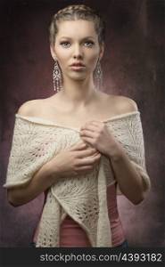 portrait of sensual brunette woman with fashion elegant style, creative hair-style and precious earrings. Covering by wool shawl