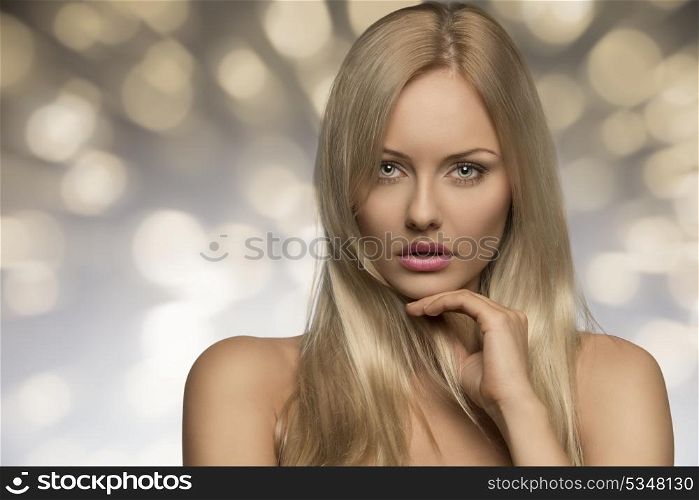 portrait of sensual young woman with naked shoulders, perfect skin and splendid blonde smooth hair