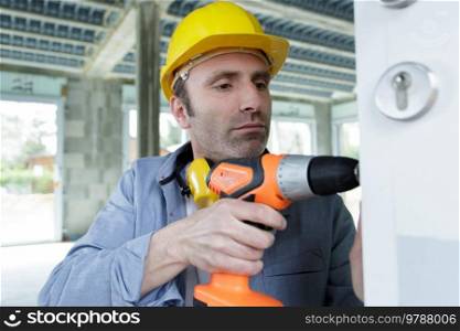portrait of serious builder man with screwdriver