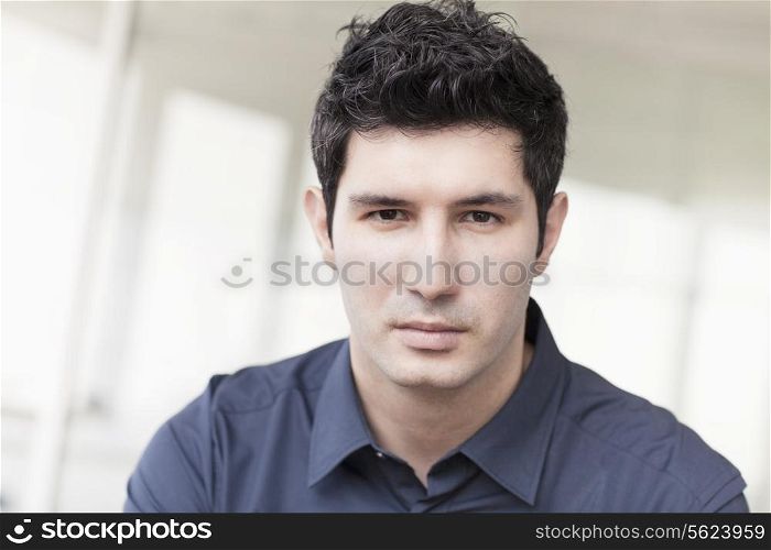 Portrait of serious businessman looking at camera