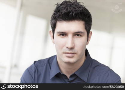 Portrait of serious businessman looking at camera