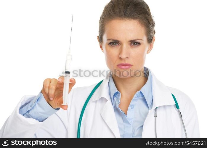 Portrait of serious doctor woman holding syringe