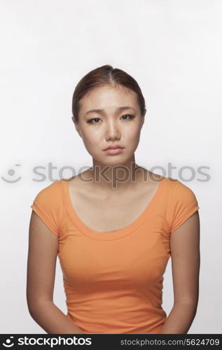 Portrait of serious teenage girl, studio shot