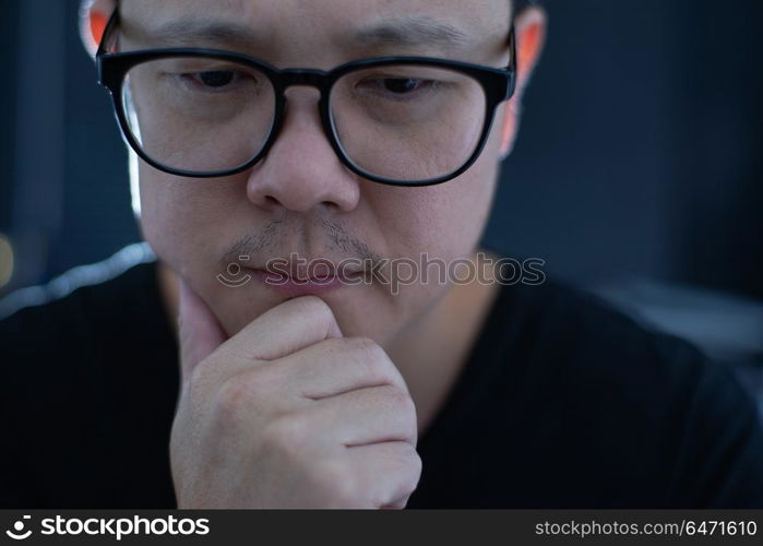 Portrait of serious young asian businessman looking at camera.