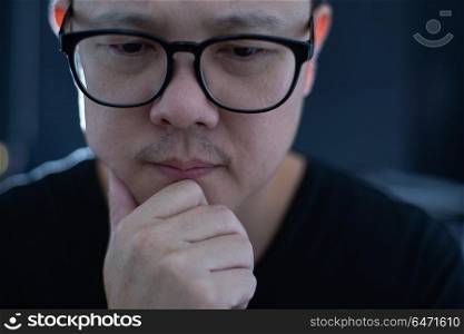 Portrait of serious young asian businessman looking at camera.