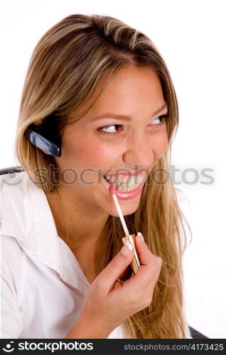 portrait of service provider doing lip make up on an isolated background
