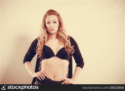 Portrait of sexy blonde woman.. Beauty of female body. Portrait of sexy young blonde woman in black. Long haired seductive girl wearing lingerie.