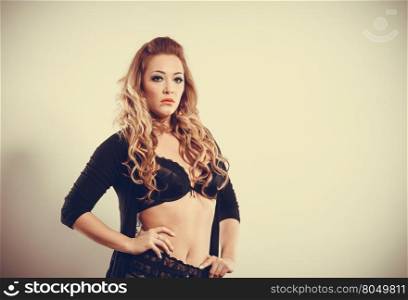 Portrait of sexy blonde woman.. Beauty of female body. Portrait of sexy young blonde woman in black. Long haired seductive girl wearing lingerie.