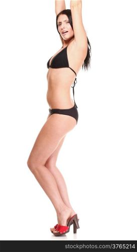 Portrait of sexy brunette in brown bikini, high heels posing istudio over white isolated