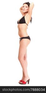 Portrait of sexy brunette in brown bikini, high heels posing istudio over white isolated