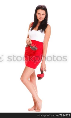 Portrait of sexy brunette in red gressi, high heels posing istudio over white isolated