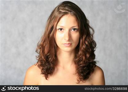 portrait of sexy brunette on grey background