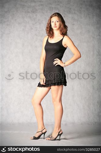portrait of sexy brunette on the grey background