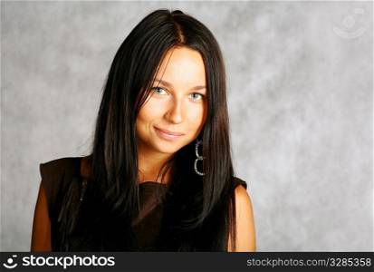 portrait of sexy brunette with good haircut on the grey background