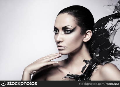 portrait of sexy brunette woman with black splash