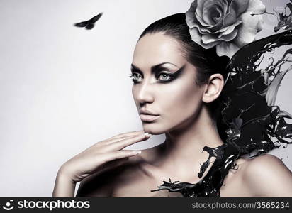 portrait of sexy brunette woman with black splash and rose