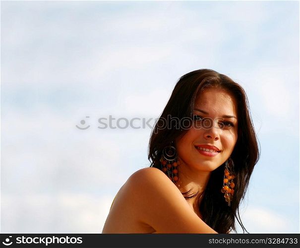 portrait of sexy girl on the background of blue sky