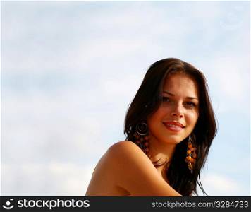 portrait of sexy girl on the background of blue sky